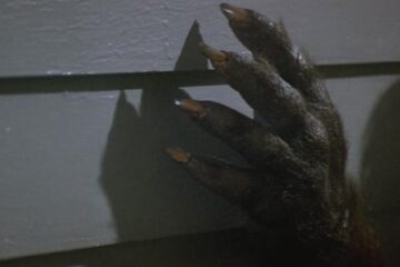 Silver Bullet 1985 Movie Scene A werewolf paw on the wall of a house