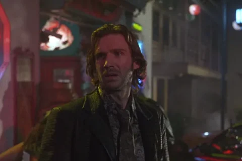 Strange Days 1995 Movie Scene Ralph Fiennes as Lenny Nero outside a seedy bar in back alley with a neon light behind him