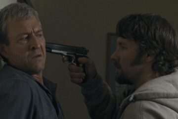 The Square 2008 Movie Scene Joel Edgerton as Billy holding a gun to David Roberts as Raymond's head and demanding the money he owes him