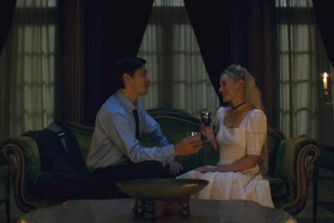 House of Darkness 2022 Movie Scene Kate Bosworth as Mina and Justin Long as Hap talking and drinking in her mansion