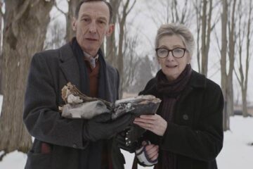 Anything For Jackson 2020 Movie Scene Sheila McCarthy as Audrey and Julian Richings as Henry reading incantations from a satanic book