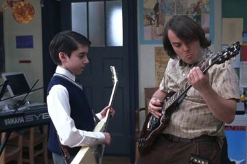 School of Rock 2003 Movie Scene Jack Black as Dewey playing guitar in a classroom with Joey Gaydos Jr. as Zack