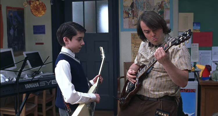 School of Rock 2003 Movie Scene Jack Black as Dewey playing guitar in a classroom with Joey Gaydos Jr. as Zack