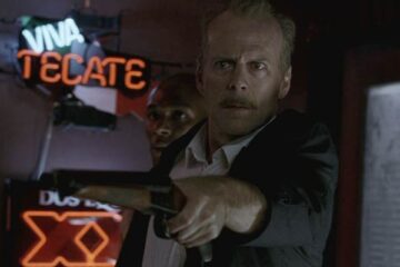 16 Blocks 2006 Movie Scene Bruce Willis as Jack Mosley holding a sawed-off shotgun with Yasiin Bey as Eddie Bunker standing behind him