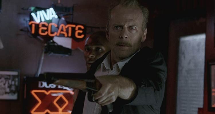 16 Blocks 2006 Movie Scene Bruce Willis as Jack Mosley holding a sawed-off shotgun with Yasiin Bey as Eddie Bunker standing behind him