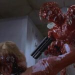 Hollow Man 2000 Movie Scene Kevin Bacon as Sebastian Caine invisible but covered in blood and holding a tranquilizer gun
