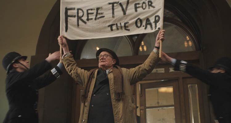 The Duke 2020 Movie Scene Jim Broadbent as Kempton Bunton protesting and demanding free television for seniors