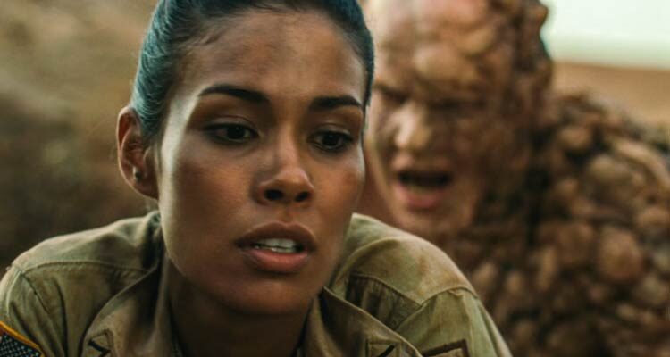 The Hills Have Eyes 2 2007 Movie Scene Daniella Alonso as Missy standing unaware that a huge mutant is about to attack her from behind