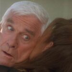 Wrongfully Accused 1998 Movie Scene Kelly LeBrock as Lauren licking Leslie Nielsen as Ryan Harrison's so hard her tongue came out of his other ear