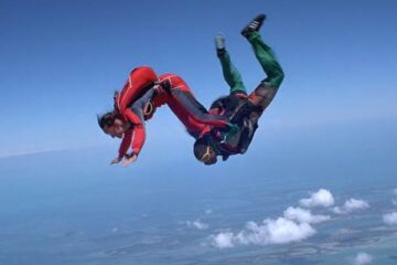 Drop Zone 1994 Movie Scene Wesley Snipes as Pete and Yancy Butler as Jessie performing stunts in the air while skydiving