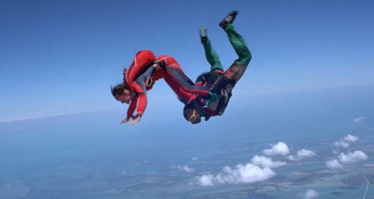 Drop Zone 1994 Movie Scene Wesley Snipes as Pete and Yancy Butler as Jessie performing stunts in the air while skydiving