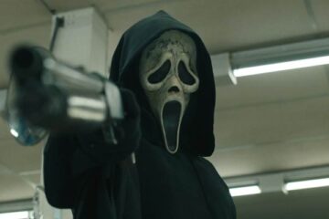 Scream VI 2023 Movie Scene Ghostface Killer wearing his mask and holding a shotgun pointed at the screen