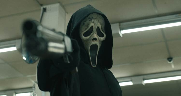 Scream VI 2023 Movie Scene Ghostface Killer wearing his mask and holding a shotgun pointed at the screen