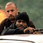 A Man Apart 2003 Movie Scene Vin Diesel as Sean Vetter and Larenz Tate as Demetrius Hicks in the middle of a shootout with cartel members