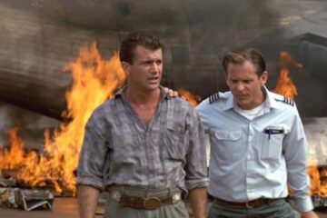 Air America 1990 Movie Scene Mel Gibson as Gene walking away from a burning wreck of an airplane with David Marshall Grant as Rob Diehl