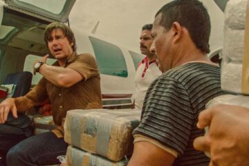 American Made 2017 Movie Scene Tom Cruise as Barry Seal instructing people to load cocaine onto his airplane