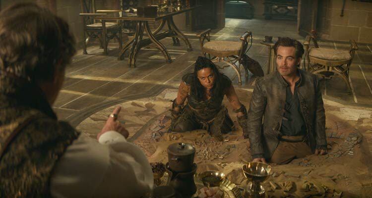 Dungeons and Dragons Honor Among Thieves 2023 Movie Scene Chris Pine as Edgin and Michelle Rodriguez as Holga stuck in quick sand
