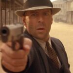 Last Man Standing 1996 Movie Scene Bruce Willis as John Smith holding his Colt 1911 handgun in the street of a small town of Jericho