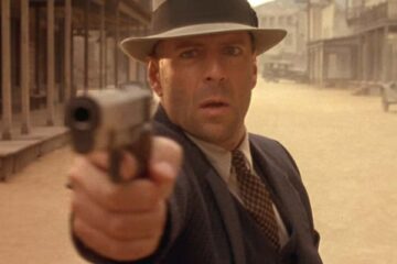 Last Man Standing 1996 Movie Scene Bruce Willis as John Smith holding his Colt 1911 handgun in the street of a small town of Jericho