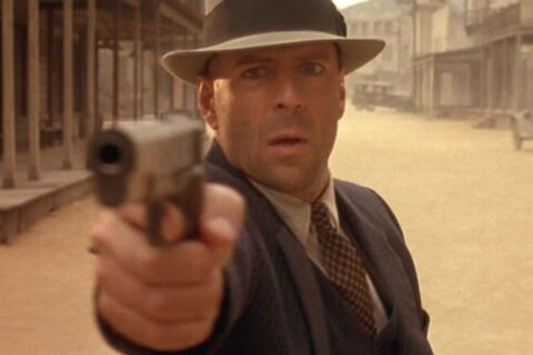 Last Man Standing 1996 Movie Scene Bruce Willis as John Smith holding his Colt 1911 handgun in the street of a small town of Jericho