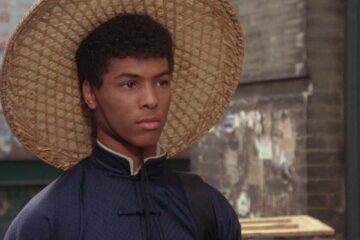 The Last Dragon 1985 Movie Scene Taimak as Bruce Leroy wearing a straw hat and a kimono