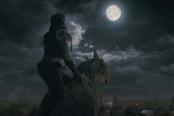 The Wolfman 2010 Movie Scene With a werewolf howling at the moon on top of a building holding on to a marble gargoyle sculpture