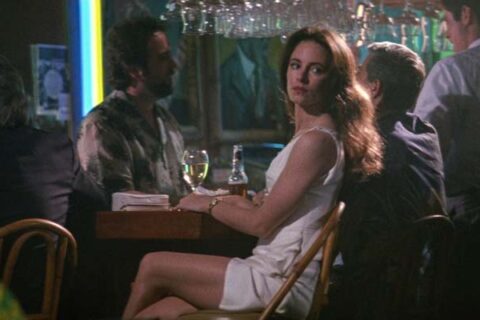 China Moon 1994 Movie Scene Madeleine Stowe as Rachel Munro in a white dress at a bar looking like a real femme fatale