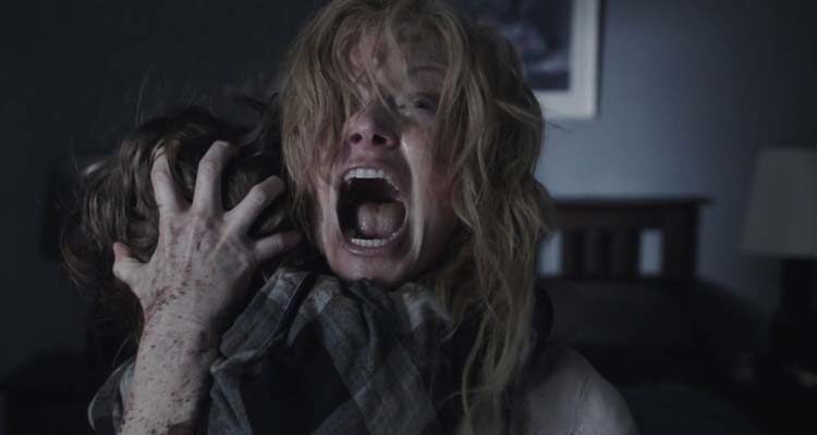 The Babadook 2014 Movie Scene Essie Davis as Amelia holding her son and screaming at the monster