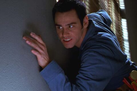 The Cable Guy 1996 Movie Scene Jim Carrey as Chip looking for the right spot on the wall to install cable tv