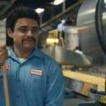 Flamin Hot 2023 Movie Scene Jesse Garcia as Richard Montañez working as a janitor at a Frito-Lay factory
