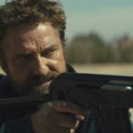 Kandahar 2023 Movie Scene Gerard Butler as Tom Harris firing his gun at the bad guys