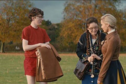 The Bromley Boys 2018 Movie Scene Brenock O'Connor as David Roberts and Savannah Baker as Ruby McQueen with her friend on the football pitch