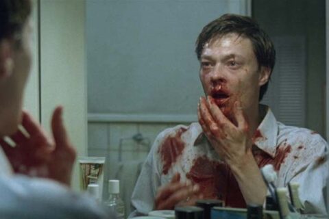 Next Door AKA Naboer 2005 Movie Scene Kristoffer Joner as John looking at his bloody face in the mirror