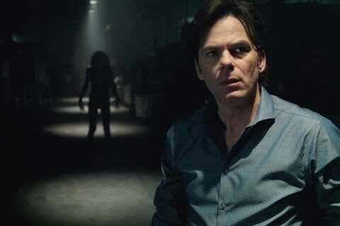 Lights Out 2016 Movie Scene Billy Burke as Paul looking into the light with a dark figure standing in shadows behind him