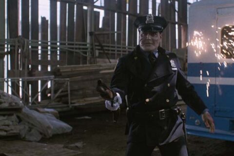 Maniac Cop 1988 Movie Scene Robert Z'Dar as Matt Cordell firing a shotgun at a police officer
