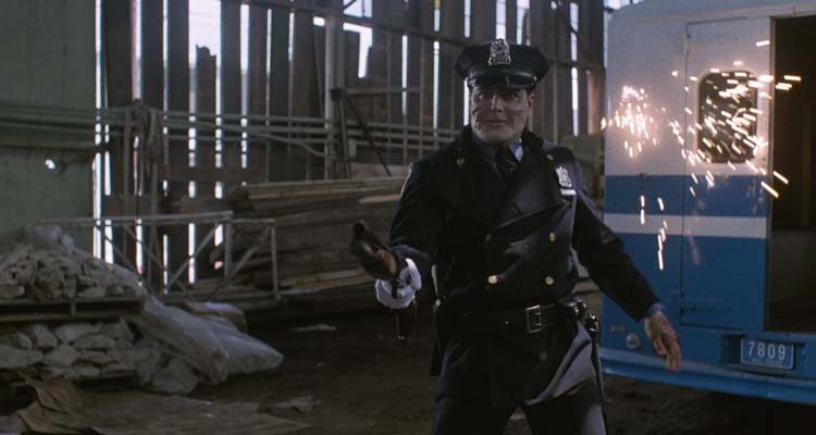 Maniac Cop 1988 Movie Scene Robert Z'Dar as Matt Cordell firing a shotgun at a police officer