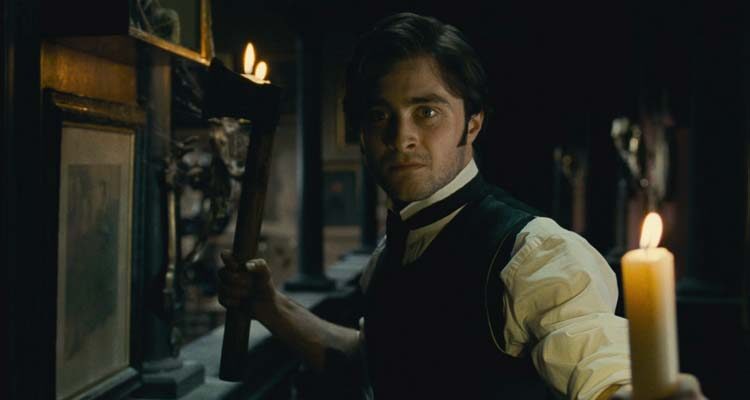 The Woman in Black 2012 Movie Scene Daniel Radcliffe as Arthur Kipps holding a candle and an axe