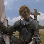 The Messenger The Story of Joan of Arc 1999 Movie Milla Jovovich as Joan of Arc riding a horse in full armor and holding her banner