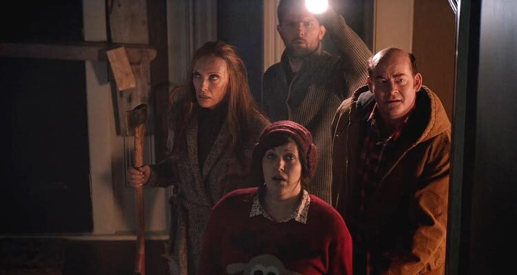 Krampus 2015 Movie Scene Toni Collette as Sarah holding an axe along with Adam Scott as Tom, David Koechner as Howard and Allison Tolman as Linda going to the attic to see what's making the noise