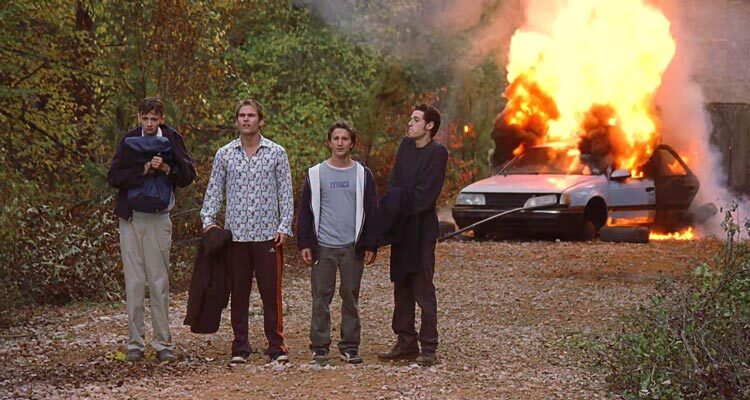 Road Trip 2000 Movie Scene Breckin Meyer as Josh, Seann William Scott as E. L., Paulo Costanzo as Rubin and DJ Qualls as Kyle with their broken car exploding in the background