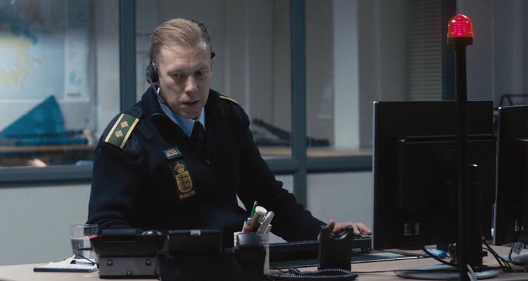 The Guilty 2018 Movie Scene Jakob Cedergren as Asger Holm as an emergency services operator talking to a kidnapped woman