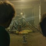 It Came From The Desert 2017 Movie Scene Harry Lister Smith as Brian and Alex Mills as Lukas seeing a giant ant eating a scientist in an underground bunker