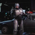 RoboCop 1987 Movie Scene Peter Weller as Alex Murphy exiting his car and holding a gun pointed at the bad guy