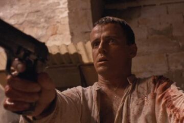 The Assignment 1997 Movie Scene Aidan Quinn as Annibal Ramirez holding a gun after he just killed a man