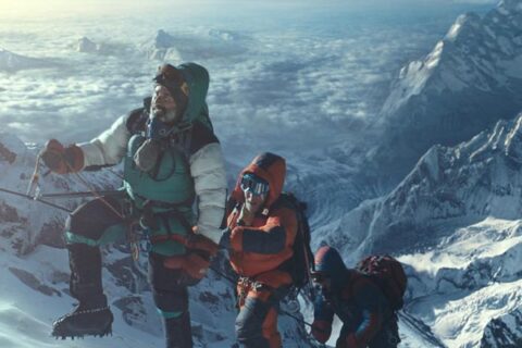 Everest 2015 Movie Scene Climbers slowly reaching the top of Mount Everest with clouds and lower mountain peaks below them