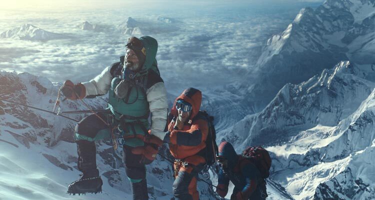 Everest 2015 Movie Scene Climbers slowly reaching the top of Mount Everest with clouds and lower mountain peaks below them