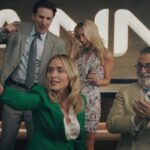 Pain Hustlers 2023 Movie Scene Emily Blunt as Liza Drake, Chris Evans as Pete Brenner and Andy Garcia as Dr. Neel celebrating the successful IPO of their pharmaceutical company Zanna