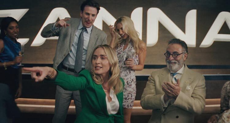Pain Hustlers 2023 Movie Scene Emily Blunt as Liza Drake, Chris Evans as Pete Brenner and Andy Garcia as Dr. Neel celebrating the successful IPO of their pharmaceutical company Zanna