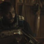 The Creator 2023 Movie Scene John David Washington as Joshua holding a laser pistol