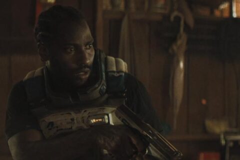 The Creator 2023 Movie Scene John David Washington as Joshua holding a laser pistol